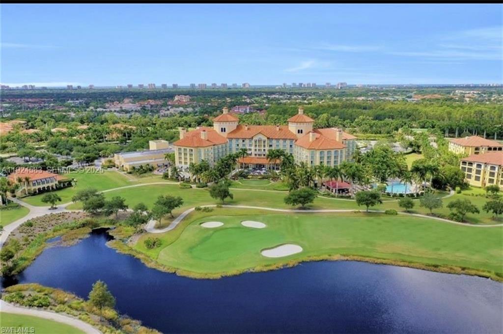 This property offers an expansive golf course with a visible water feature, surrounded by lush green landscaping and mature trees