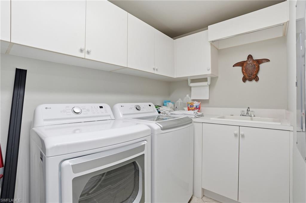The laundry area features white cabinetry, a sink with a faucet, and white appliances