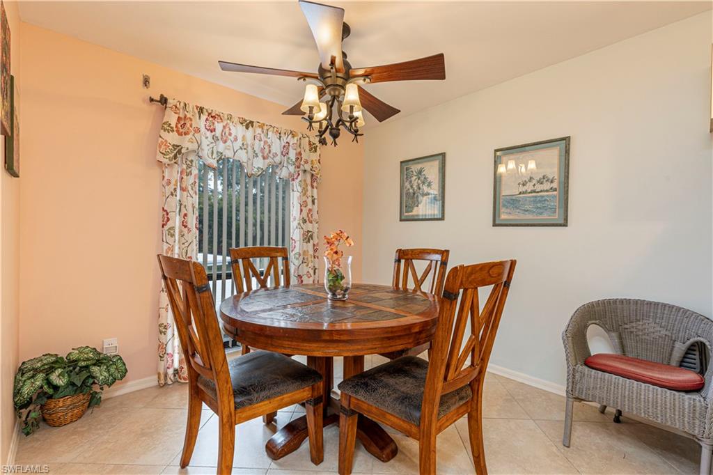 Tiled dining area featuring ceiling fan