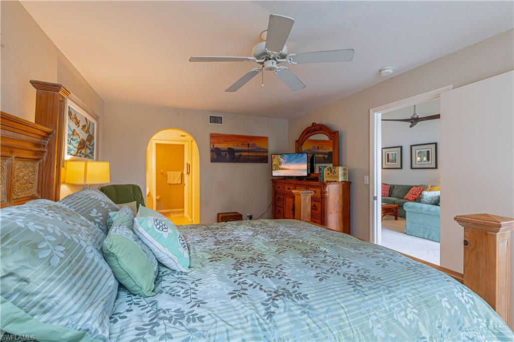 Carpeted bedroom featuring ceiling fan
