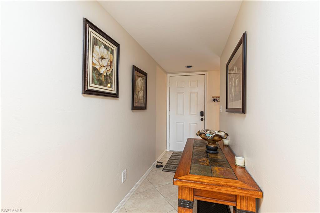 Hallway with light tile patterned floors