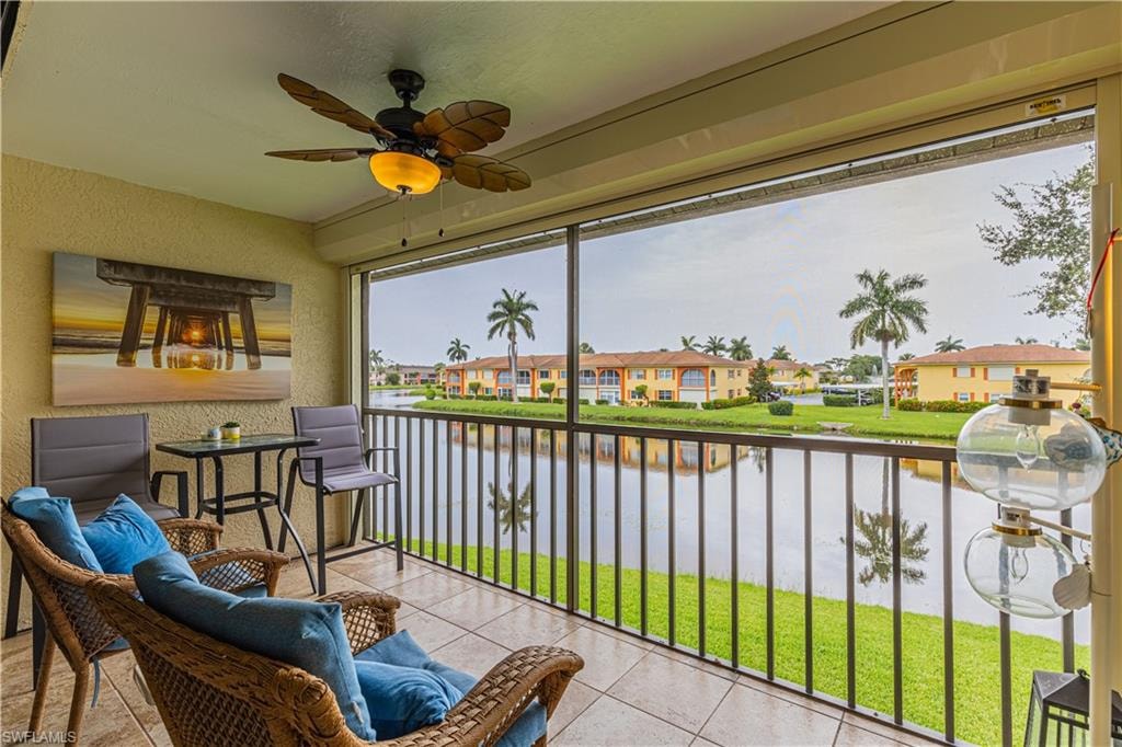 Sunroom with a water view and ceiling fan