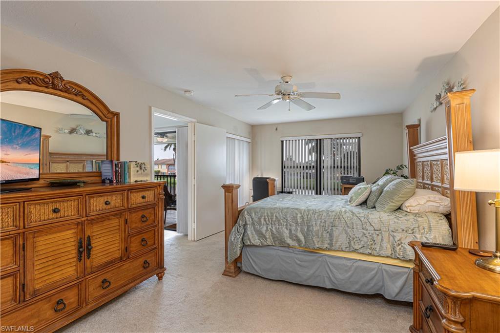 Carpeted bedroom with ceiling fan