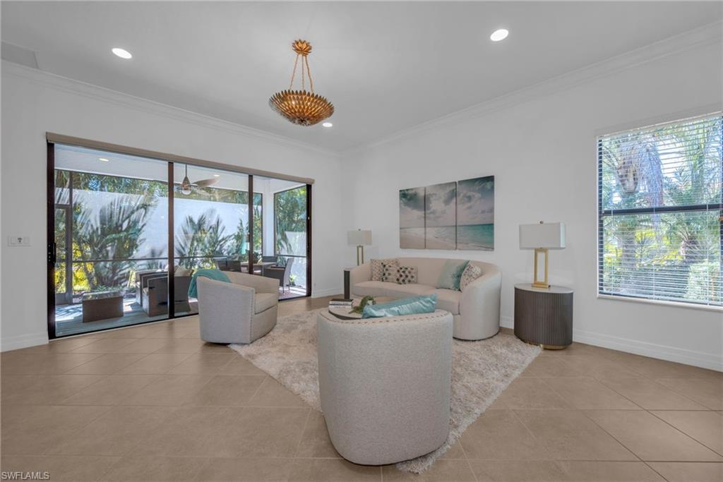 Bright open-concept living area with large windows and seamless indoor-outdoor flow.