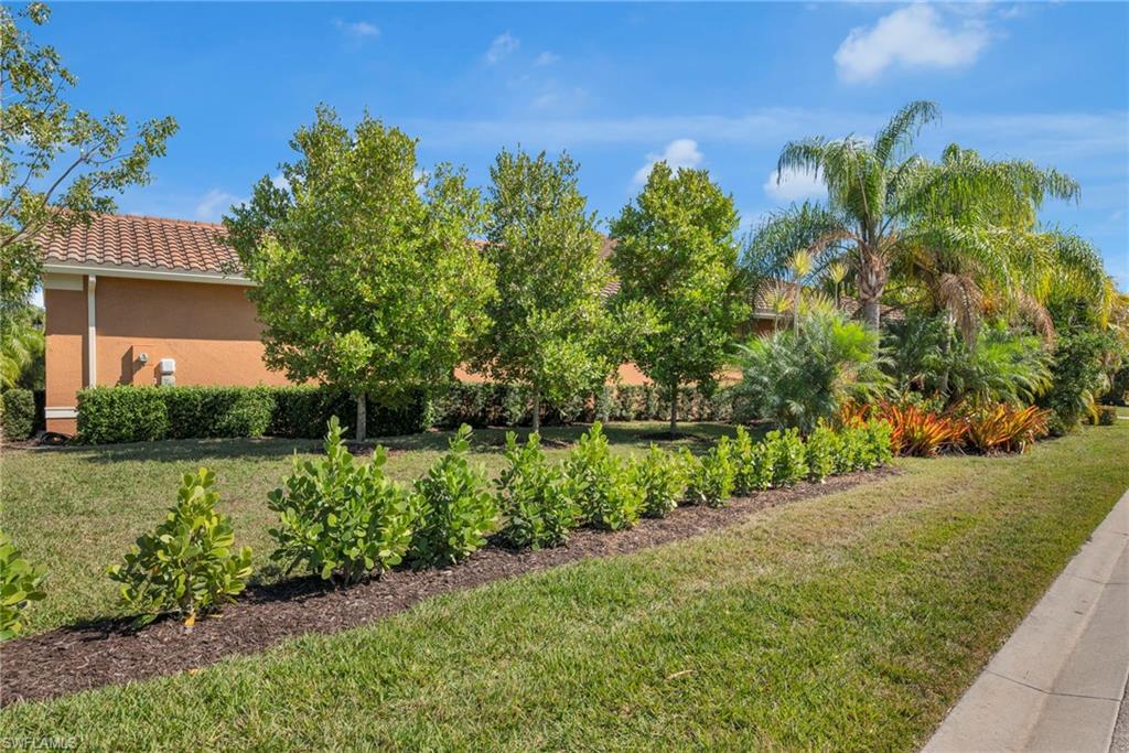 Expansive side yard with lush tropical landscaping and serene garden views.