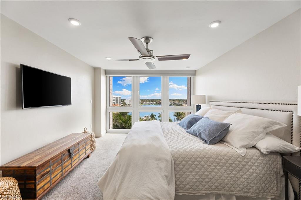 Carpeted bedroom featuring ceiling fan and recessed lighting