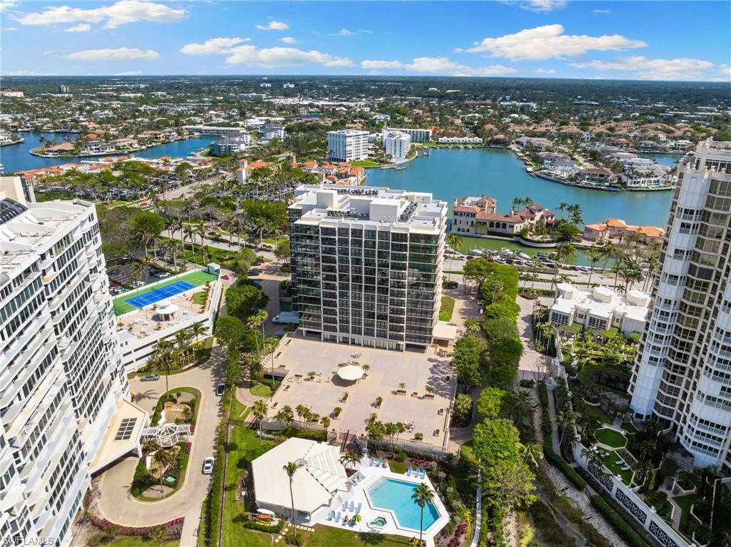 View of urban area with a large body of water and a pool area