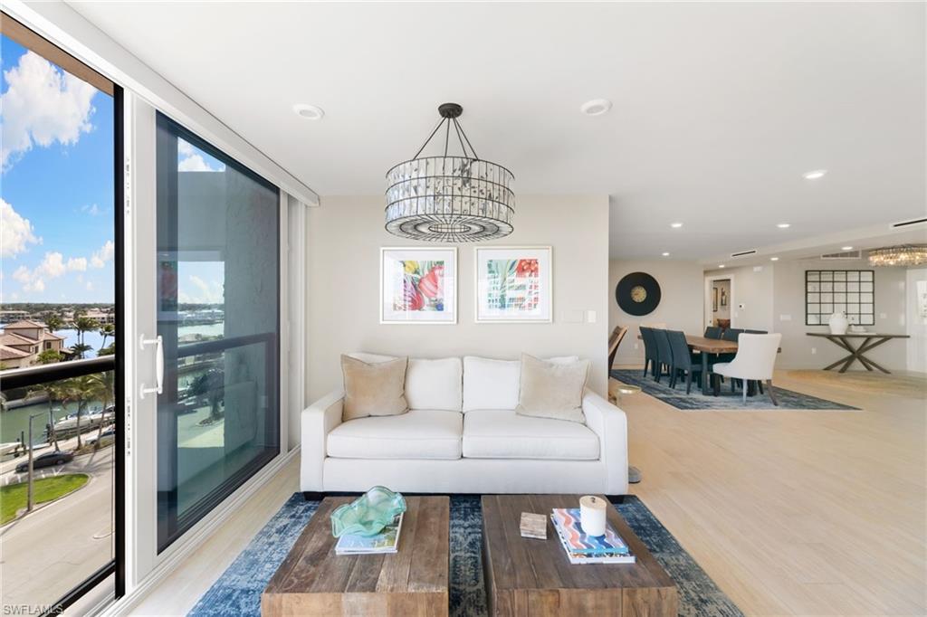 Living area featuring a chandelier, wood finished floors, plenty of natural light, and recessed lighting