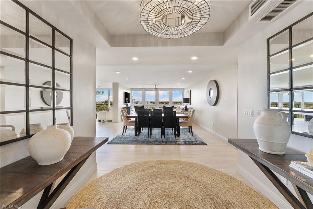 Dining room featuring light wood-style floors, recessed lighting, baseboards, and a chandelier