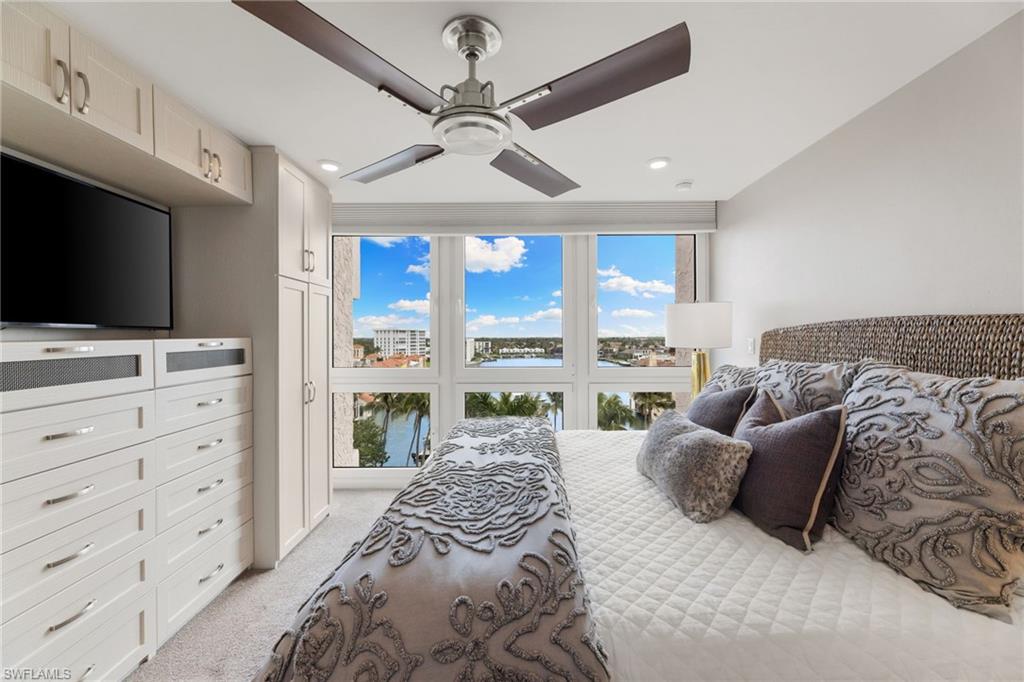 Bedroom featuring light colored carpet, multiple windows, ceiling fan, and recessed lighting