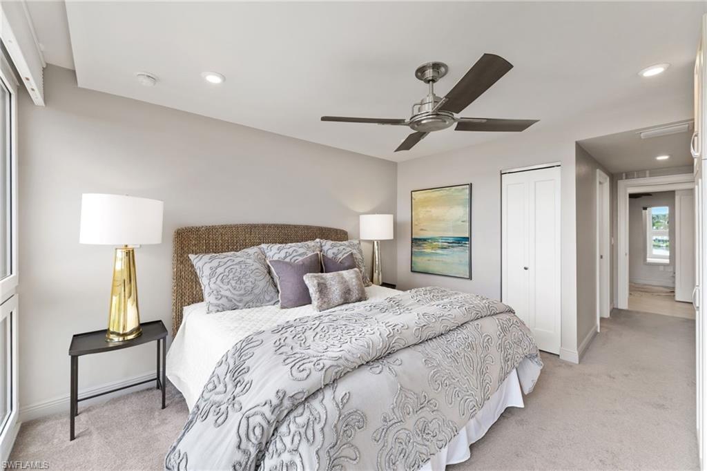 Bedroom with light colored carpet, a closet, baseboards, recessed lighting, and a ceiling fan
