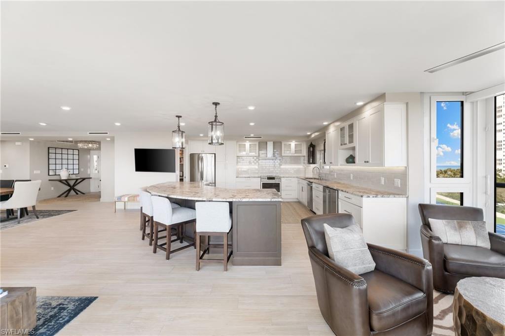 Kitchen featuring appliances with stainless steel finishes, a sink, white cabinets, recessed lighting, and glass insert cabinets