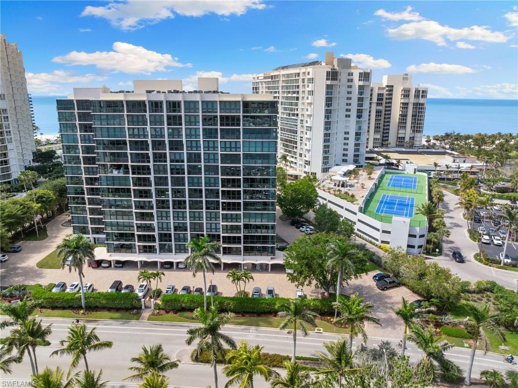 View of apartment building / complex with a water view and a view of city