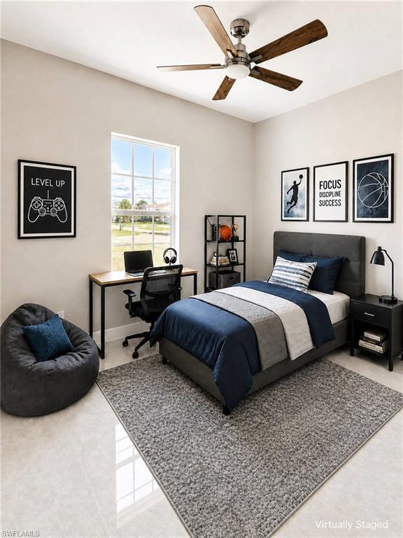 Bright room featuring a large window, a ceiling fan with wood-finish blades, and tile flooring