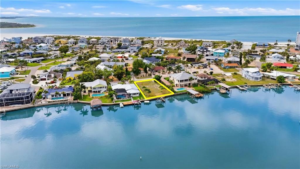 Aerial view of residential area featuring a nearby body of water - Virtually Edited Image
