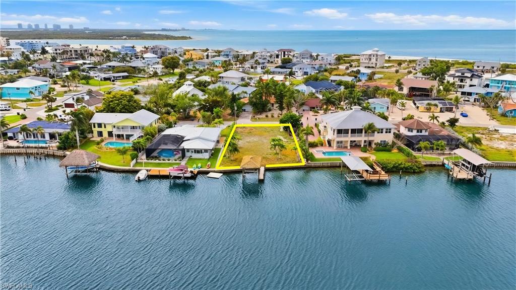 Aerial view of residential area featuring a large body of water - Virtually Edited Image