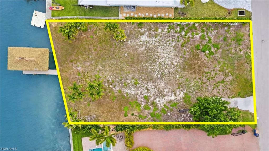 Aerial view of property's location featuring property parcel outlined - Virtually Edited Image