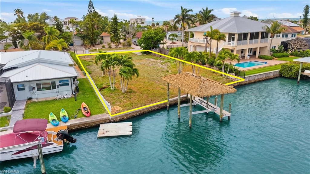 Drone / aerial view of a nearby body of water and a pool area - Virtually Edited Image
