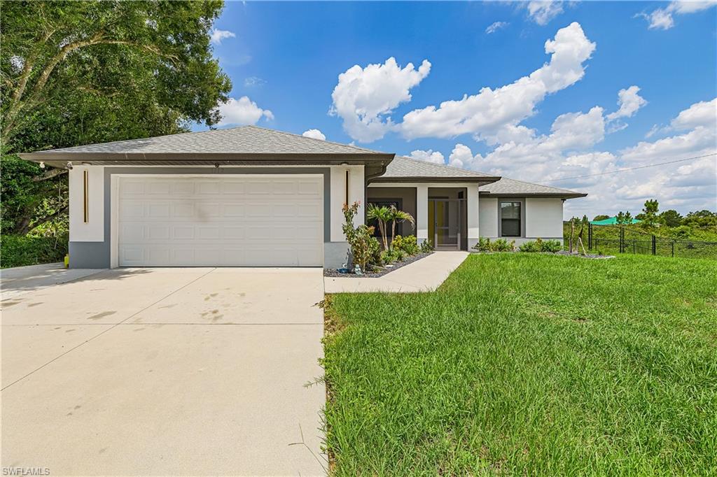 Contemporary exterior with a covered entry, attached garage, and a concrete driveway