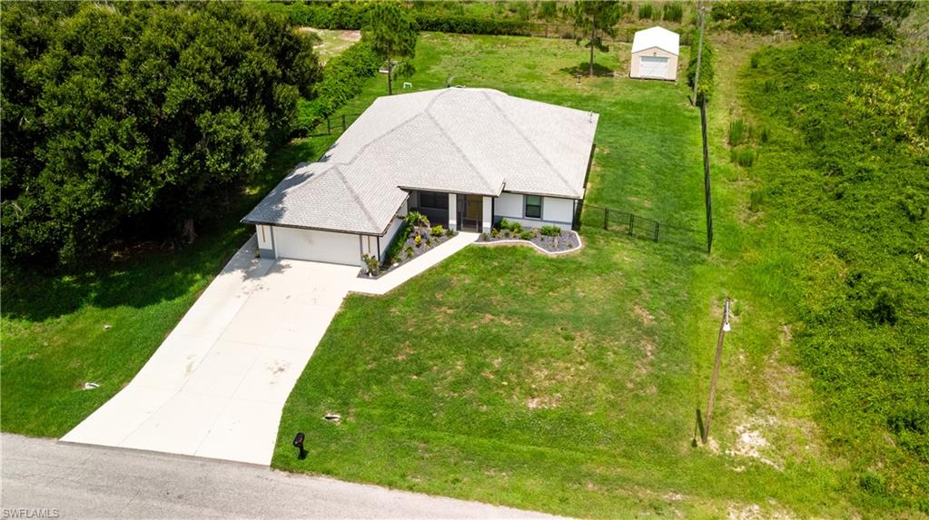 Ranch-style residence featuring a prominent front-facing garage and a concrete driveway