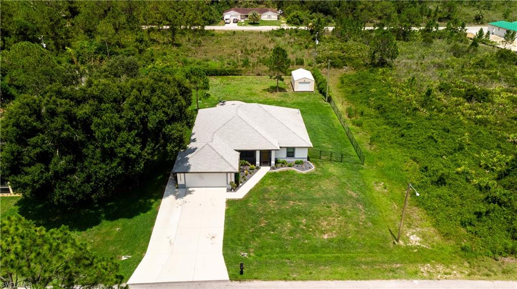 Single-story residence featuring a gray shingle roof, attached two-car garage, and a concrete driveway