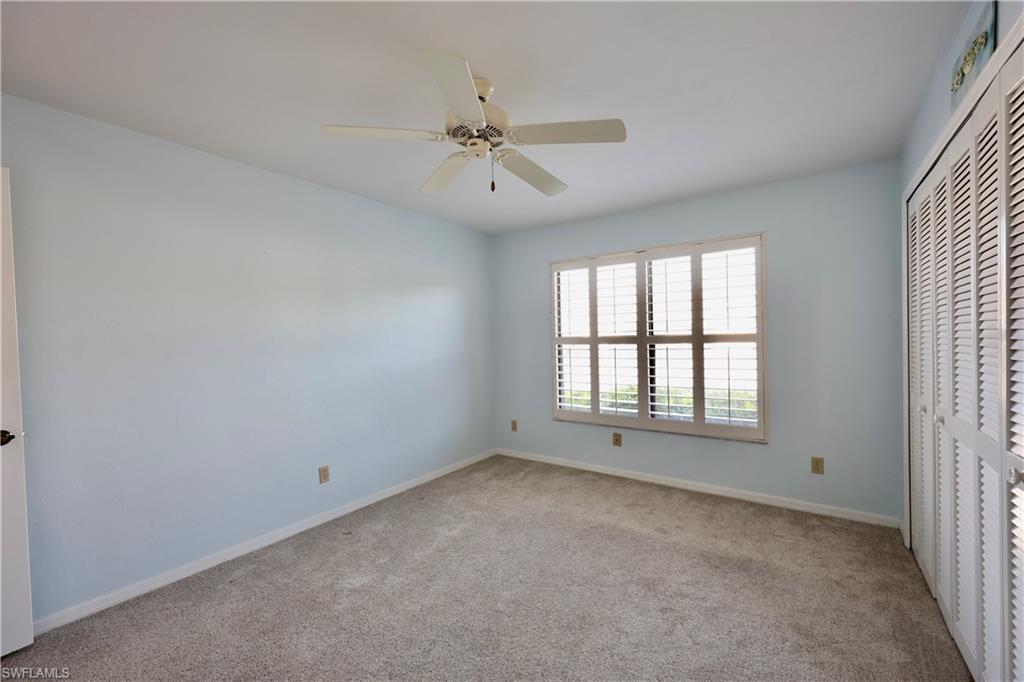 Unfurnished bedroom featuring light carpet, a closet, and ceiling fan