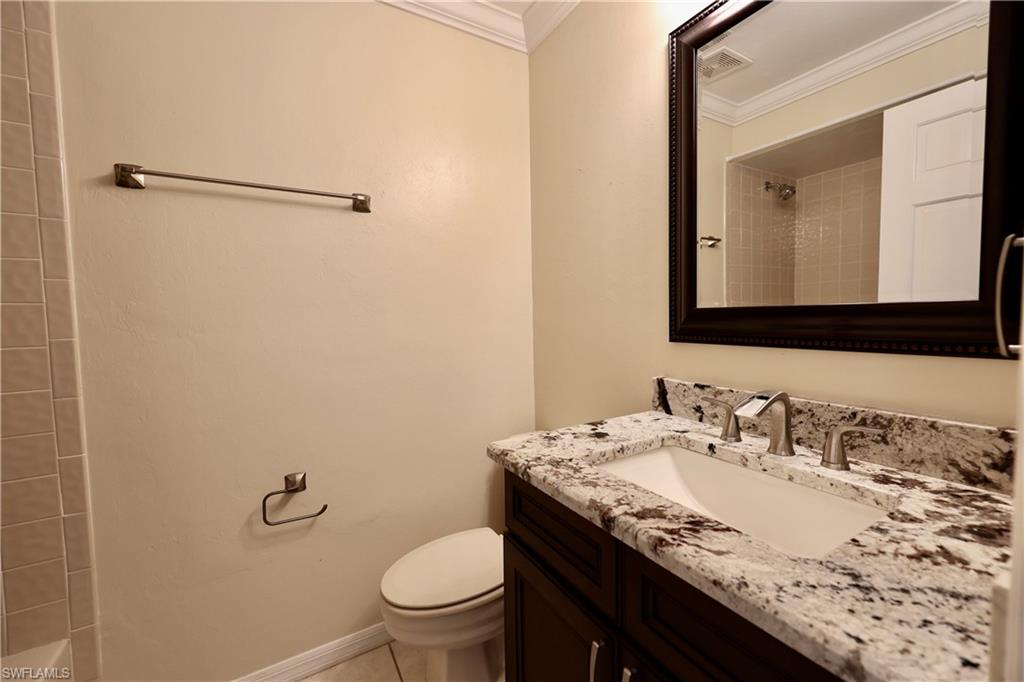 Full bath featuring vanity and crown molding
