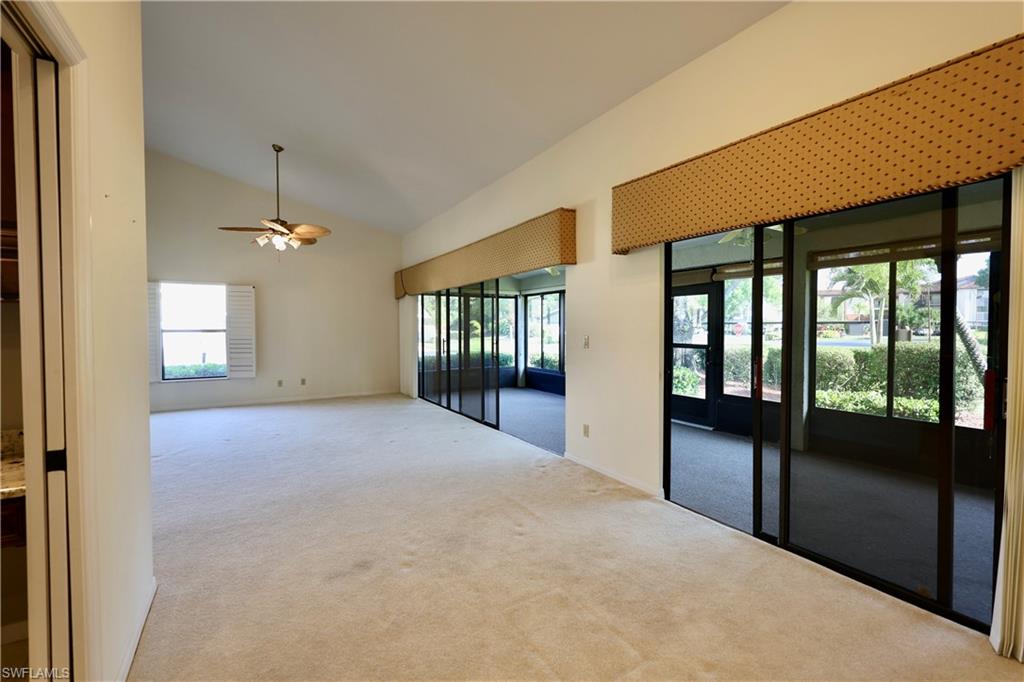 Spare room with carpet, lofted ceiling, and ceiling fan