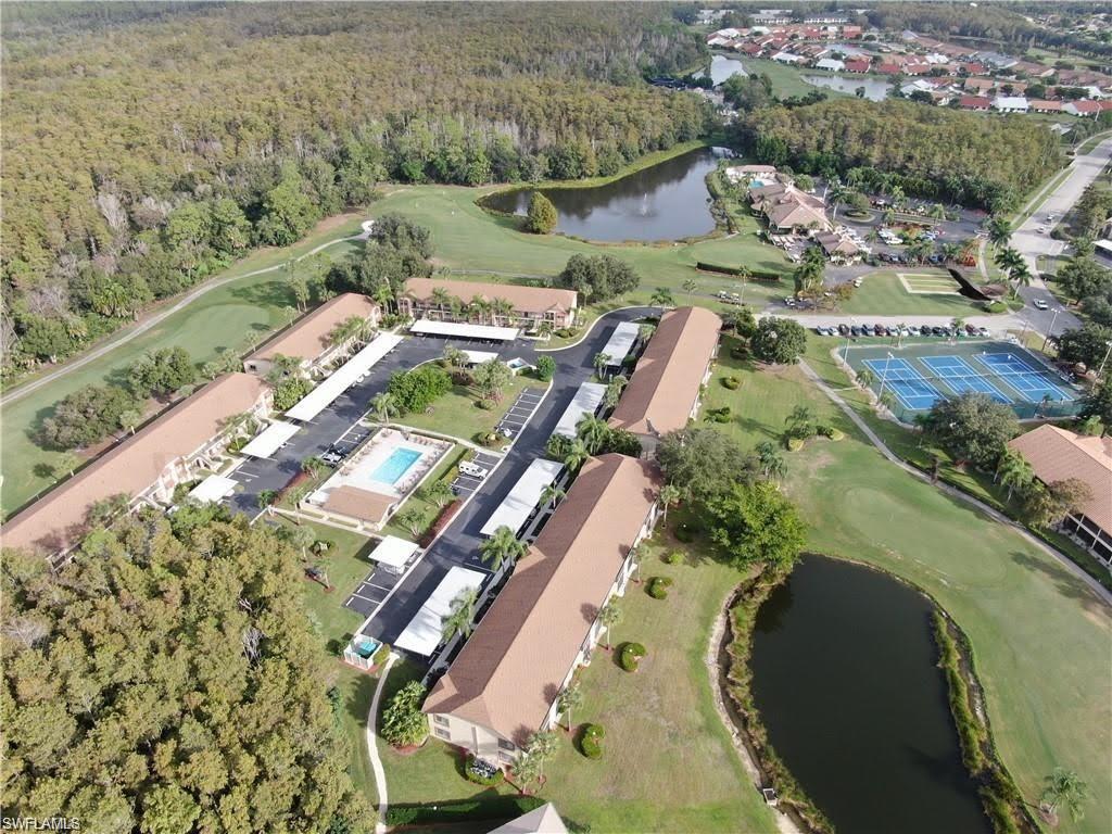 Drone / aerial view of a nearby body of water and a golf club