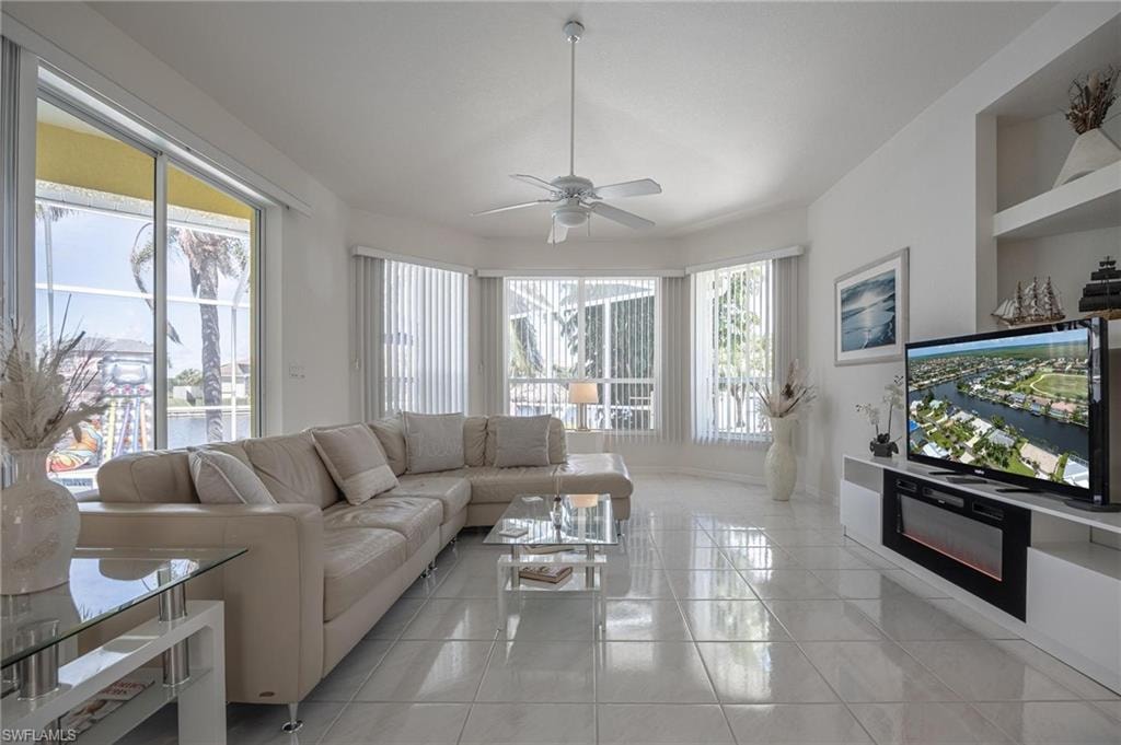Living room featuring ceiling fan and light tile patterned floors