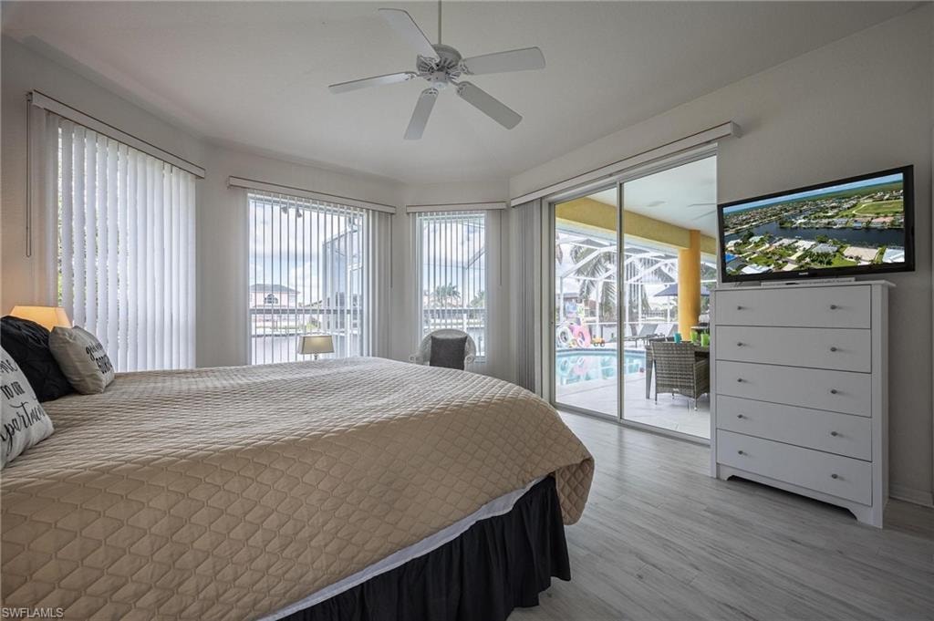 Bedroom featuring access to outside, light wood-style flooring, and ceiling fan