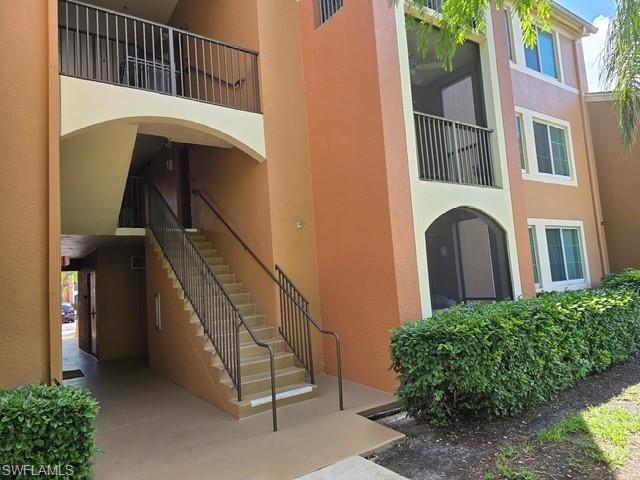 View of apartment building / complex featuring stairs