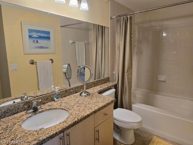 Full bathroom featuring vanity, shower / bathtub combination with curtain, and light tile patterned floors