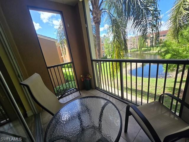 Balcony with a water view and outdoor dining area
