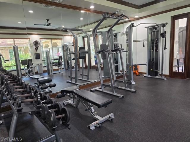 Exercise room featuring ceiling fan, recessed lighting, ornamental molding, and a raised ceiling