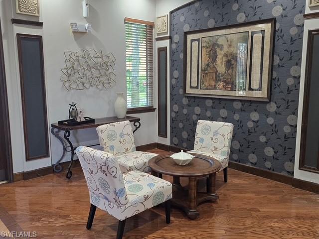 Living area with baseboards and wood finished floors
