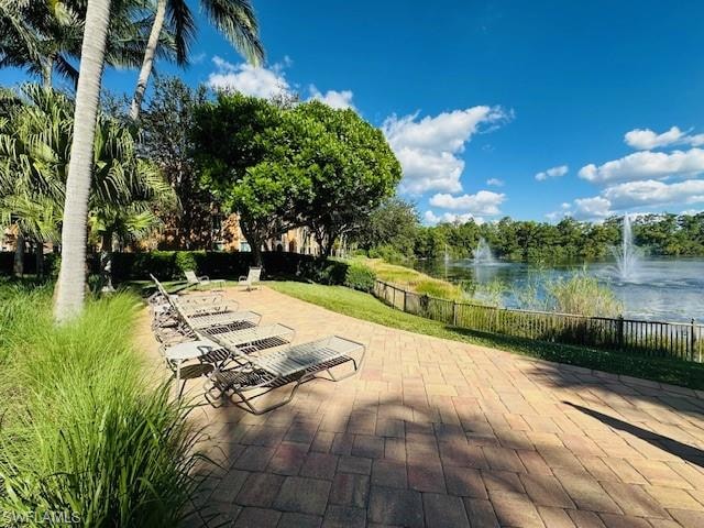 View of community featuring a water view and a patio area