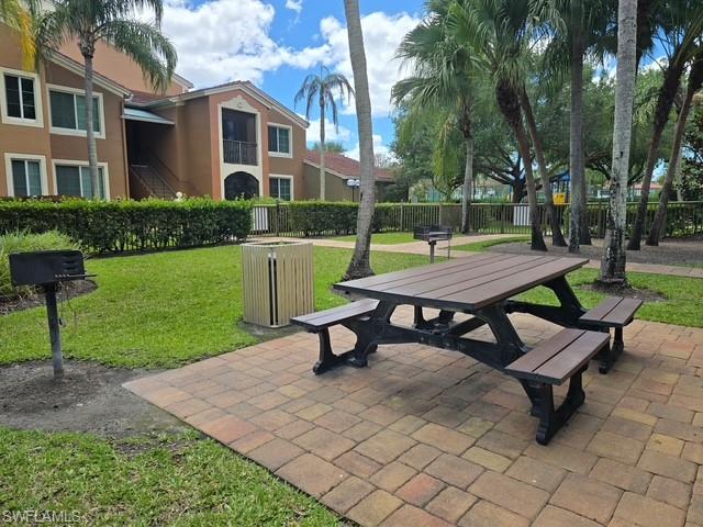 View of community with outdoor dining area and a patio