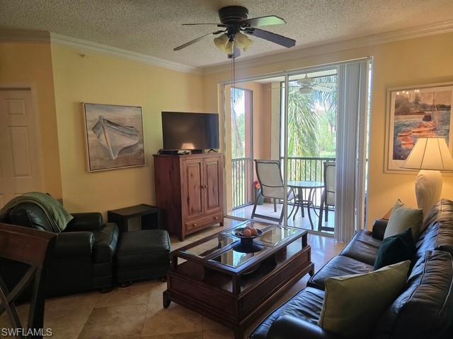 Living room featuring crown molding, a textured ceiling, and ceiling fan