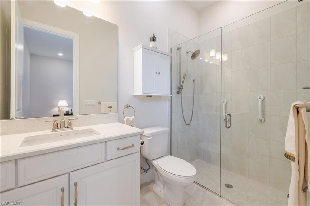 Bathroom featuring vanity and a shower stall