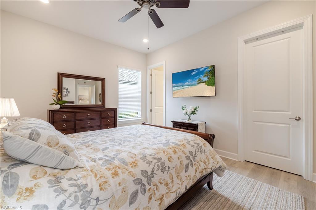 Bedroom with light wood-style floors, recessed lighting, and a ceiling fan