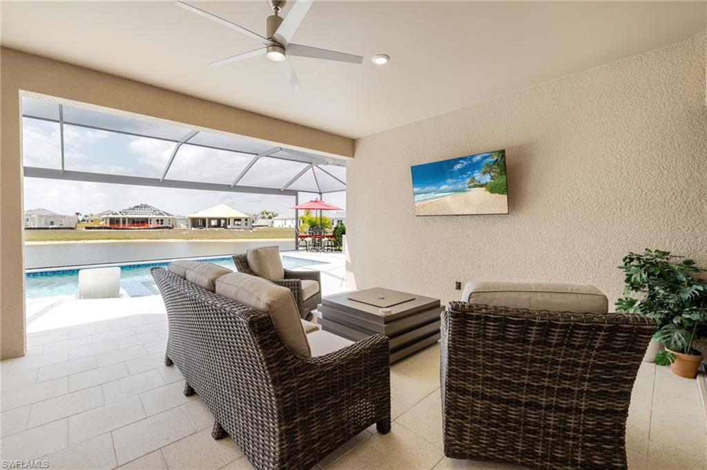 View of patio / terrace with a ceiling fan, a sunroom, an outdoor pool, a lanai, and a residential view