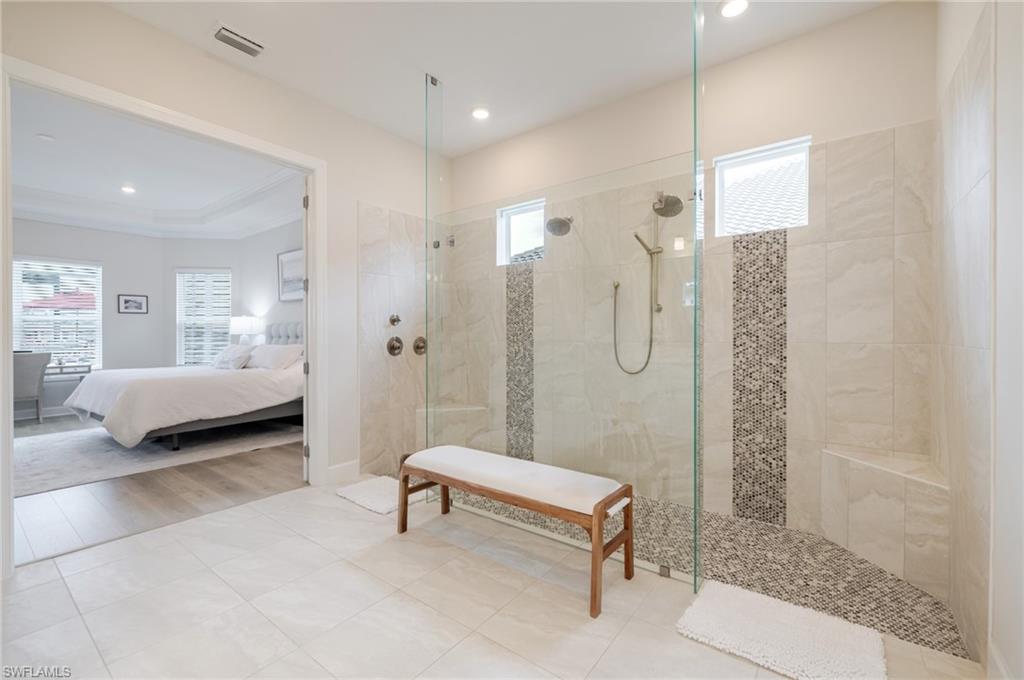 Ensuite bathroom with a walk in shower and light tile patterned floors