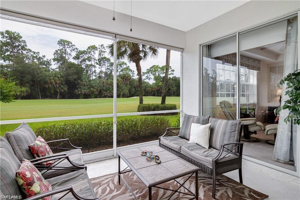 Private screened lanai overlooking the golf course, offering a comfortable outdoor living space with peaceful fairway views.