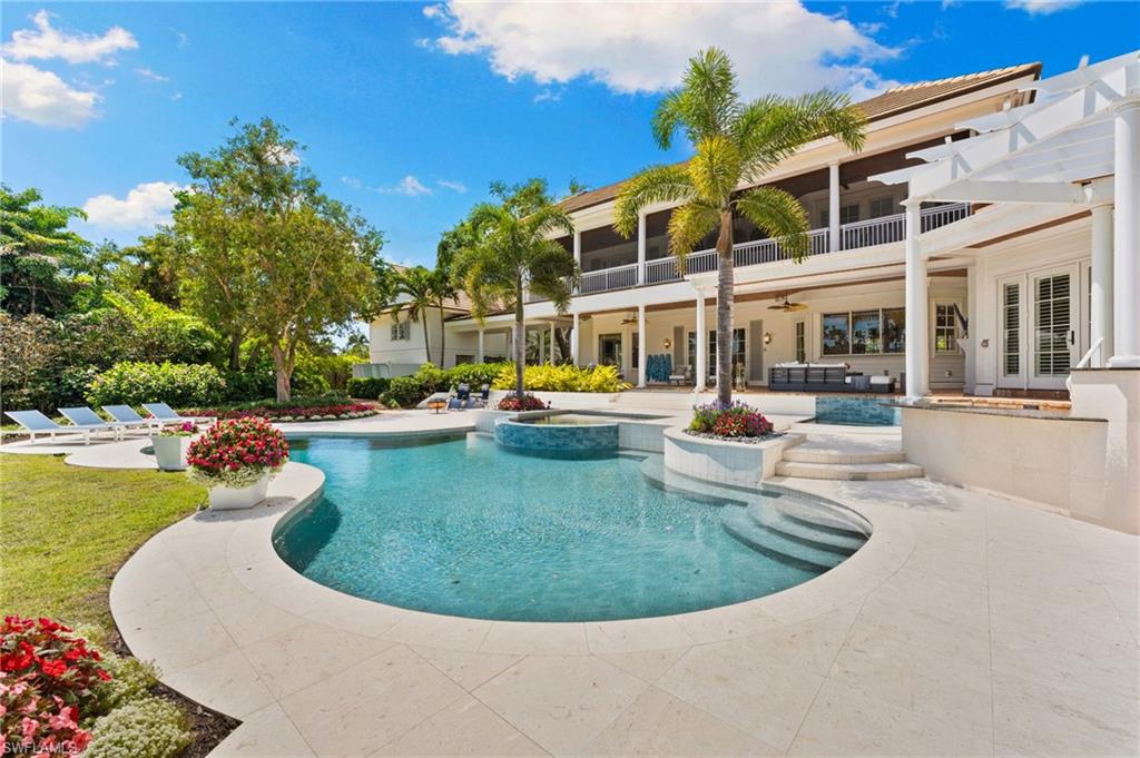View of pool with a patio area, ceiling fan, and a pool with connected hot tub