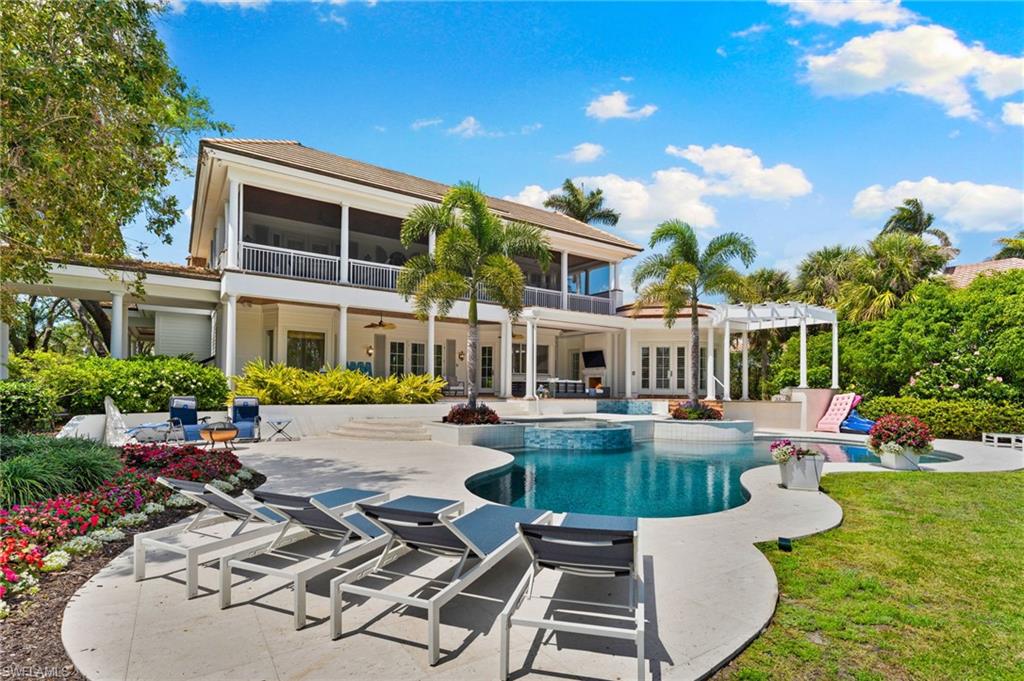 Back of house with a pergola, a patio, french doors, and a sunroom