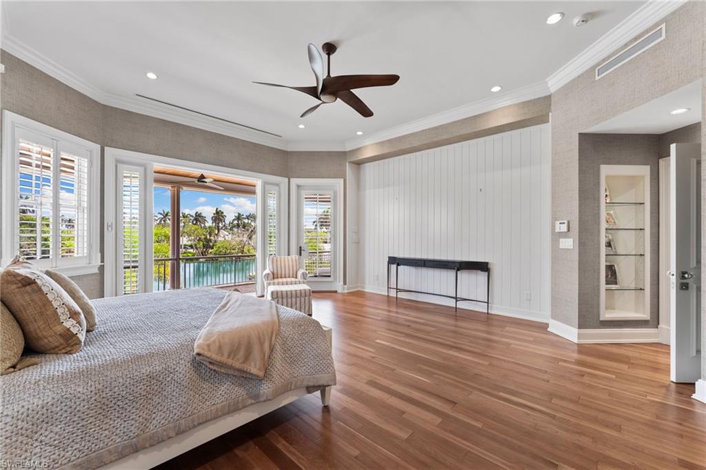 Bedroom featuring access to exterior, wood finished floors, baseboards, and recessed lighting