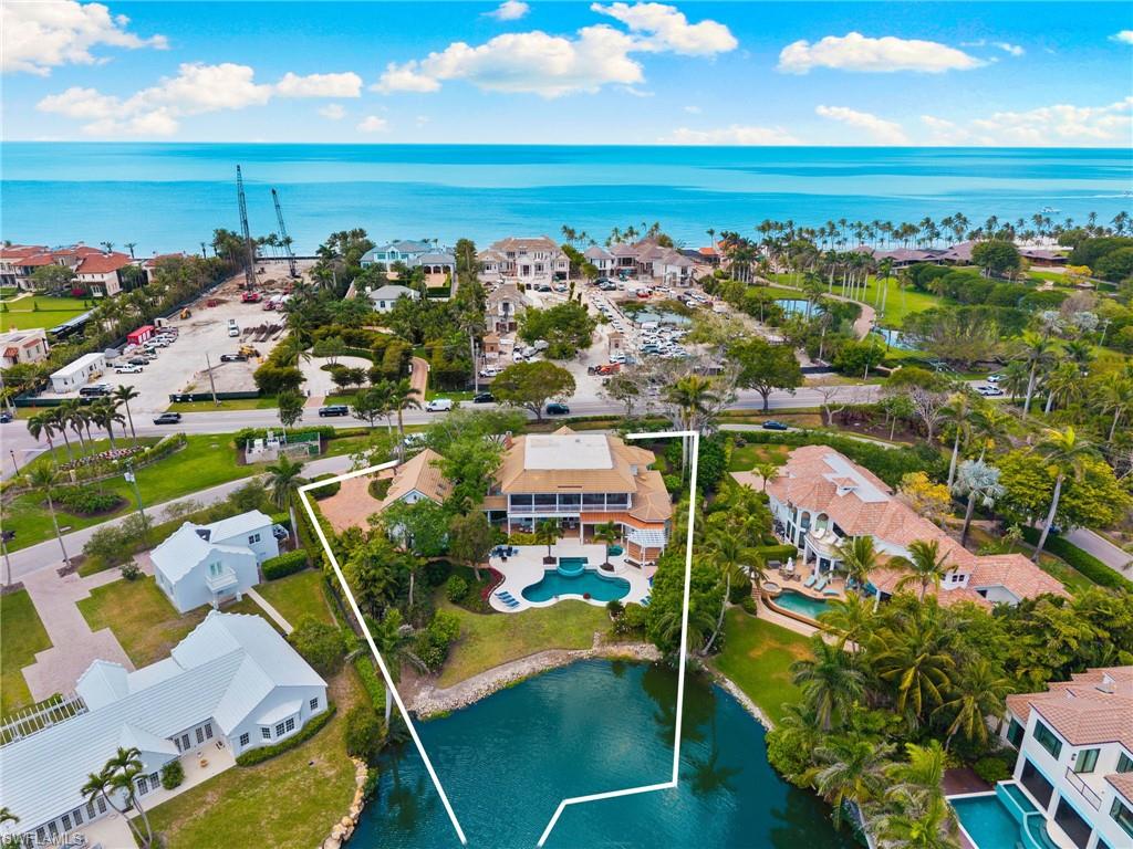 Birds eye view of property with a water view and a residential view