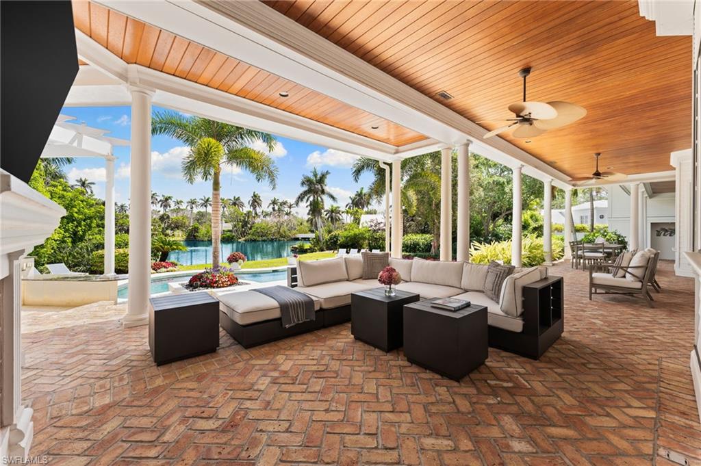 View of patio with a water view, a ceiling fan, an outdoor hangout area, and an outdoor pool