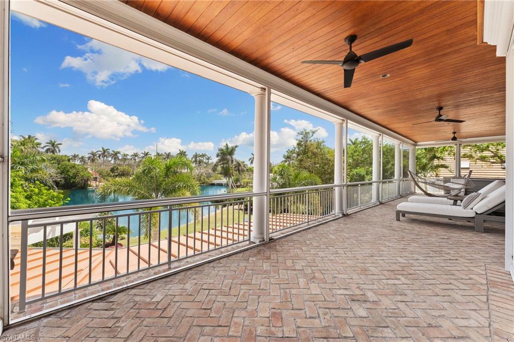 View of patio featuring ceiling fan and a water view